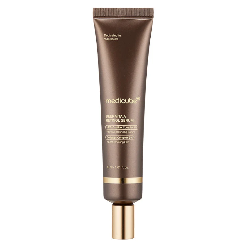 A dark bronze tube of Medicube Deep Vita A Retinol Serum with gold accent bands and a gold cap.