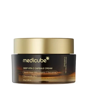 A dark amber translucent jar of Medicube Deep Vita C Capsule Cream topped with a satin gold lid.