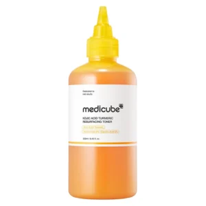A translucent round bottle filled with bright orange Medicube Kojic Acid Turmeric Resurfacing Toner topped with a yellow pointed nozzle cap.