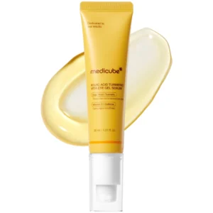 Front view of a bright yellow tube with a clear pump cap for Medicube Kojic Acid Turmeric Vita Eye Gel Serum set against a gel swatch.