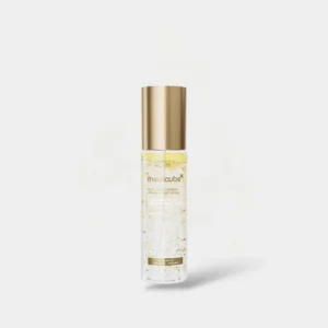 Clear spray bottle topped with a gold cap showing suspended jelly droplets inside Medicube Kojic Acid Turmeric Vita Jelly Mist Serum.