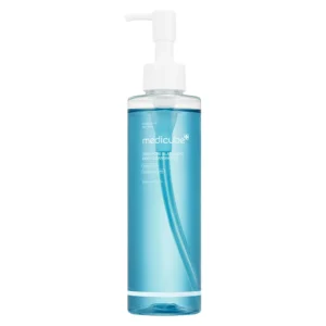 A clear pump bottle containing light blue Medicube Zero Pore Blackhead Deep Cleansing Oil